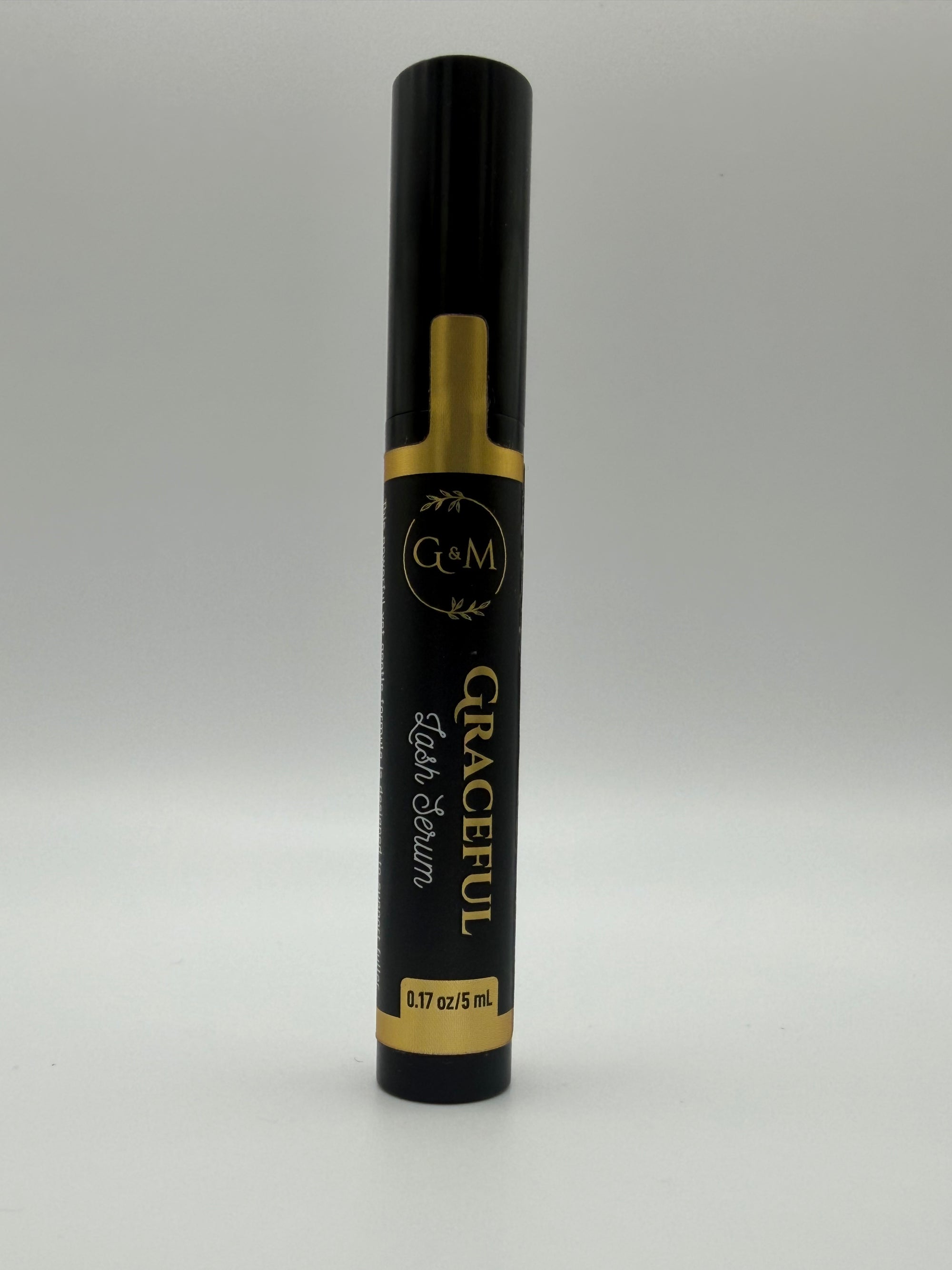 Black and gold lashtube on a white background