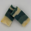 Two bars of green and beige soap on a white background