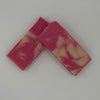 Two pink and white marbled soap bars on a white background