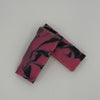 Marbled pink and black rectangular soap on a light gray background